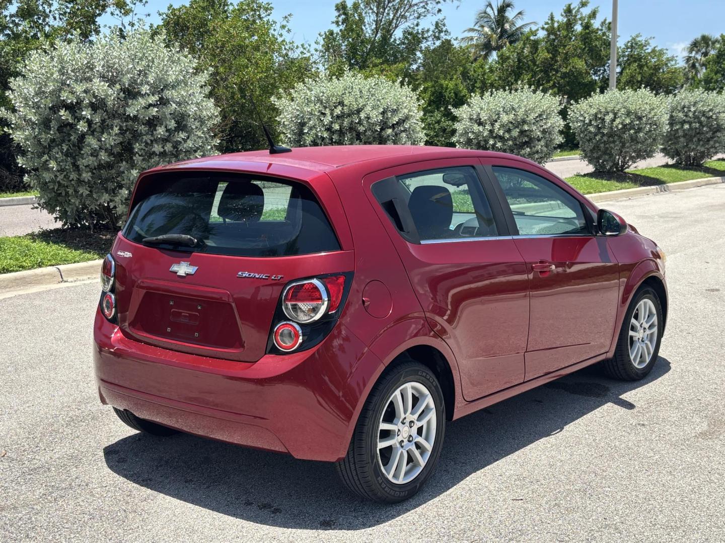 2013 RED Chevrolet Sonic LT Auto 5-Door (1G1JC6SH1D4) with an 1.8L L4 DOHC 24V FFV engine, 6-Speed Automatic transmission, located at 11170 Summerlin Square Dr., Fort Myers Beach, FL, 33931, (239) 999-7777, 26.493546, -81.941628 - Photo#4